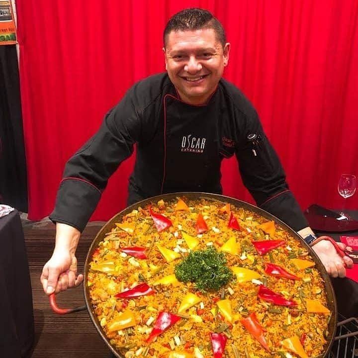 Chef Oscar with a large saffron paella